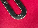 a close up of a metal chain on a red surface