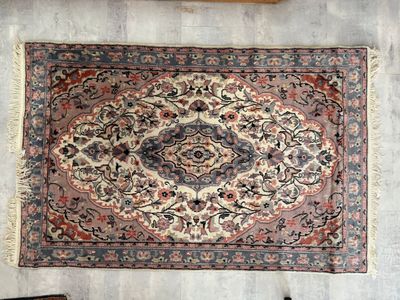 un tapis posé à même le sol, à côté d'une chaise, dans une pièce