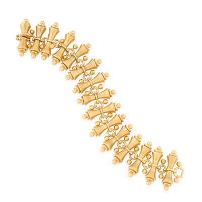 a close up of a gold bracelet on a white background