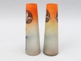 pair of orange and white vases with fish design on them