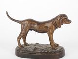 bronze statue of a dog standing on a base on a white background