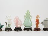 five different colored vases sitting on top of each other
