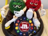 three m & m ' s sitting on top of a telephone