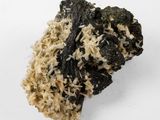 a close up of a piece of black and white rock on a white surface
