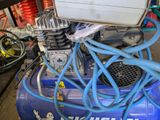 a blue air compressor sitting on top of a table