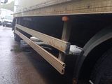 two trucks that are parked on the side of the road
