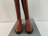 brown leather boots on a box on a white surface