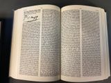 an open book with arabic writing on it on a table