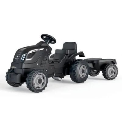 un tracteur jouet noir avec une remorque, sur fond blanc