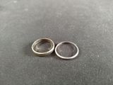 two wedding rings sitting on top of a table