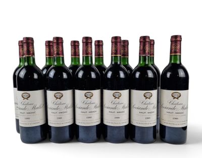 six bottles of red wine lined up in a row on a white surface
