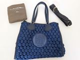a blue purse and a wallet on a white table