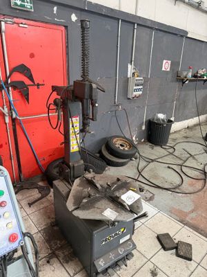 an image of a garage with a lot of tools on the floor