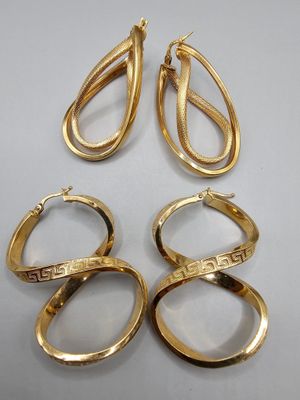 three pairs of gold rings and a pair of earrings