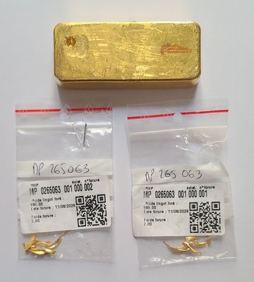 two gold bars and a piece of paper with qr code on them