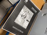 a picture of a book on a desk next to a printer