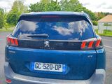 a blue car that is parked in a parking lot