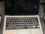 a laptop that is sitting on a desk next to a keyboard