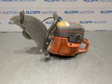 a chainsaw is sitting on the floor in front of a wall