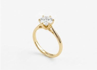 a yellow gold engagement ring with a round diamond