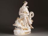 a figurine of a woman sitting on top of a table
