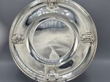 a silver plate with a lion head design on the rim