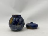 two blue vases sitting next to each other on a white surface