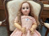 a doll that is sitting on a chair in a room