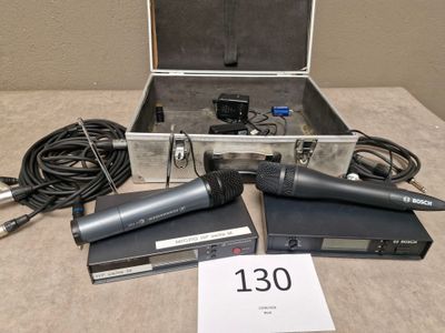 three microphones sitting in a case on a table