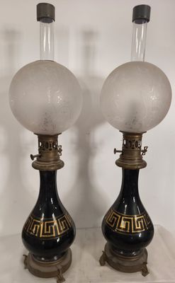 pair of black and gold table lamps with frosted glass globes