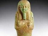 a close up of a statue of a person holding a bowl