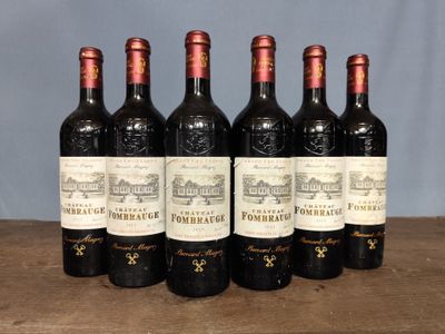 six bottles of wine are lined up on a wooden table