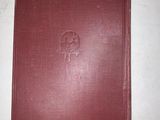 an old book on a table with a piece of paper sticking out of it