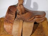a wooden horse saddle with a saddle on top of it
