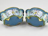 pair of blue and gold vases with flowers on them