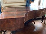 a grand piano in the middle of a wooden floor