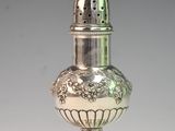 a silver salt and pepper shaker sitting on a table