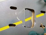 a person that is cutting a hole in a piece of paper