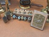 a lot of antique brass items on the ground