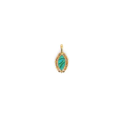 a gold and green stone pendant on a white background