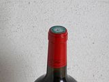 a bottle of wine sitting on a table next to a bottle of wine