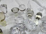 a lot of glassware on a table with a white table cloth