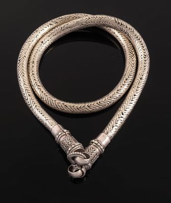 a silver snake head necklace on a black background