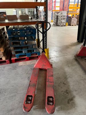 two skis that are sitting on a pallet in a warehouse