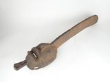 an old wooden pipe clamp with a wooden handle on a white surface