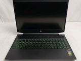 the laptop is open on a white surface with a green keyboard