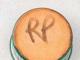 a close up of a wooden object with the letter r painted on it