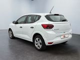 the rear end of a white car parked in a room