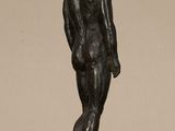 bronze statue of a man standing on a marble base