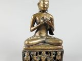an image of a statue of a person sitting in a lotus position